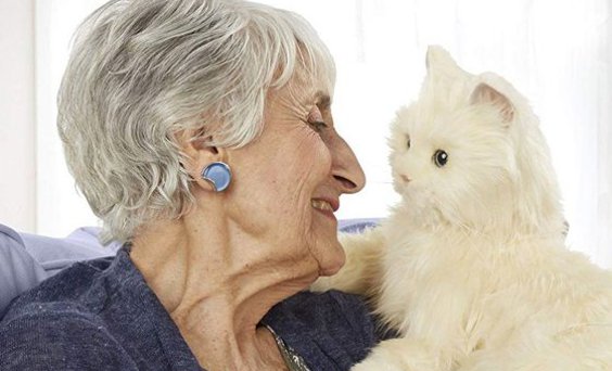 Older woman cuddling and gazing into the eyes of a white toy cat