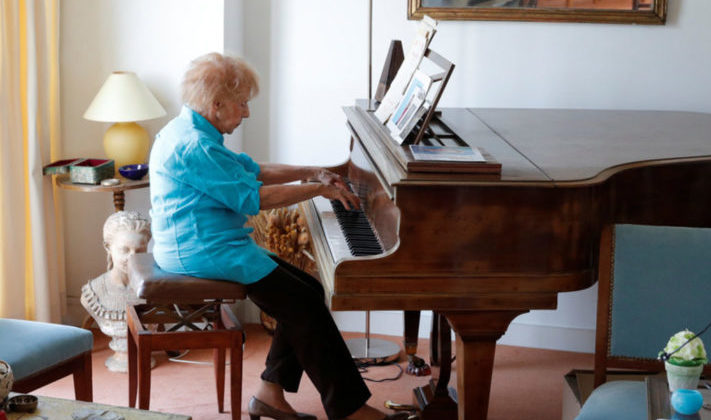 Pianist Colette Maze seated at her piano. She has just recorded her sixth album at the age of 106.
