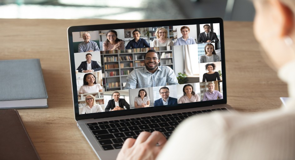 A woman views a vitual meeting on a laptop screen