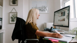 Older woman working at a computer in home office