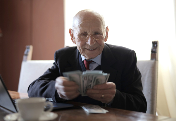 Older businessman counting money